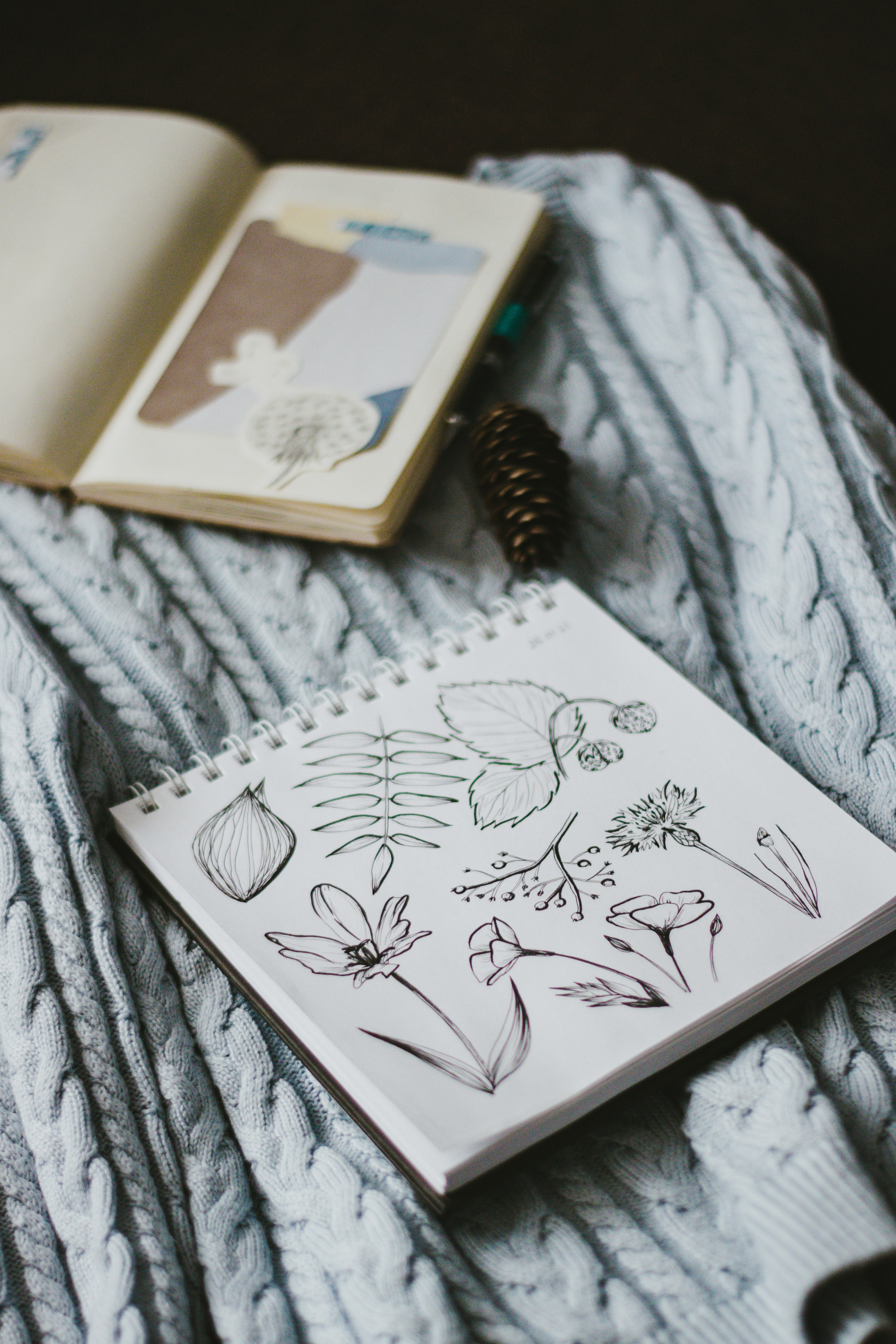 white and brown book on white textile